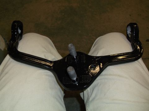 1999 Mercury Grand Marquis - This black metal tow hitch receiver has two threaded bolts extending from its central mounting plate.