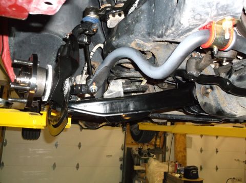 1999 Mercury Grand Marquis - Close-up view of vehicle suspension and brake components being worked on.