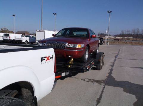1999 Mercury Grand Marquis - Red 1999 Mercury Grand Marquis loaded onto a trailer for transport.