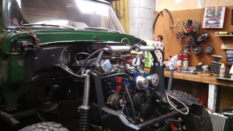 1967 Ford F-250 - Front view of a 1967 Ford F-250 engine bay during a build, showing the engine and suspension components.