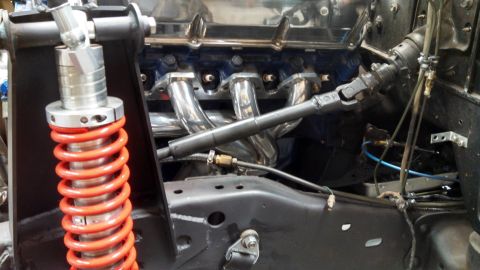 1967 Ford F-250 - Engine bay details showing chrome exhaust headers and a custom suspension component.