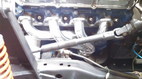 1967 Ford F-250 - Close-up view of engine components including exhaust headers and steering linkage.