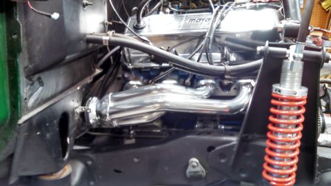 1967 Ford F-250 - Close-up of engine components including chrome headers and a red coilover shock.