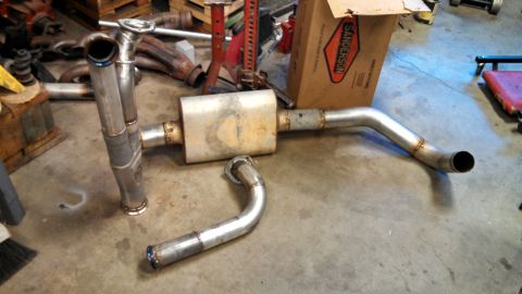 1967 Ford F-250 - Custom exhaust components are laid out on the floor, with a Sanderson box visible in the background.