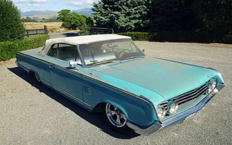 1964 Mercury Monterey - A turquoise 1964 Mercury Monterey convertible is parked outdoors on a sunny day.