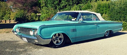 1964 Mercury Monterey - Teal 1964 Mercury Monterey convertible with a white soft top and custom wheels.