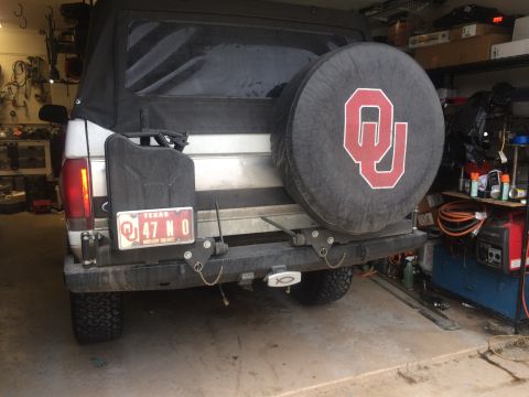 1996 Ford Bronco - Rear view of a 1996 Ford Bronco showing spare tire, jerry can, and aftermarket bumper.