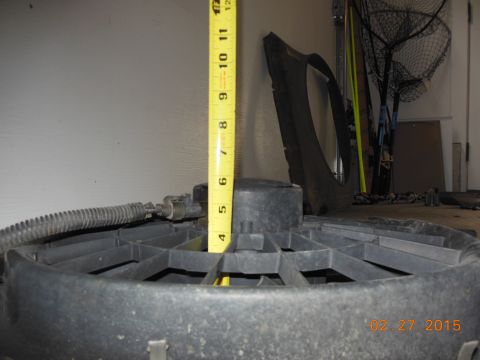 1979 Ford F-150 - A radiator fan is measured with a tape measure, with other parts and tools in the background.