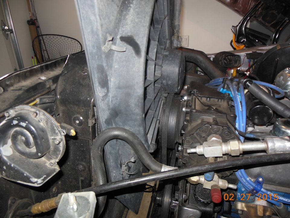 Engine bay view showing fan, horn, and engine components