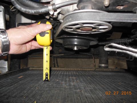 1979 Ford F-150 - Measuring clearance near the engine belt and pulley system above the radiator.