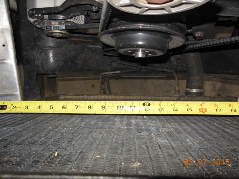 1979 Ford F-150 - A tape measure is placed across the top of a radiator, showing engine components above.