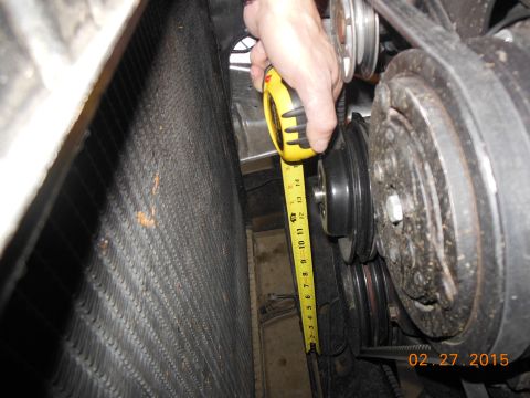 1979 Ford F-150 - Measuring engine bay clearance with a tape measure next to a radiator.