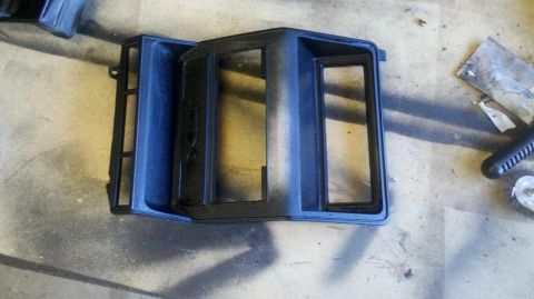 1982 Ford Bronco - Dashboard trim piece, possibly for a 1982 Ford Bronco, shown on a work surface.