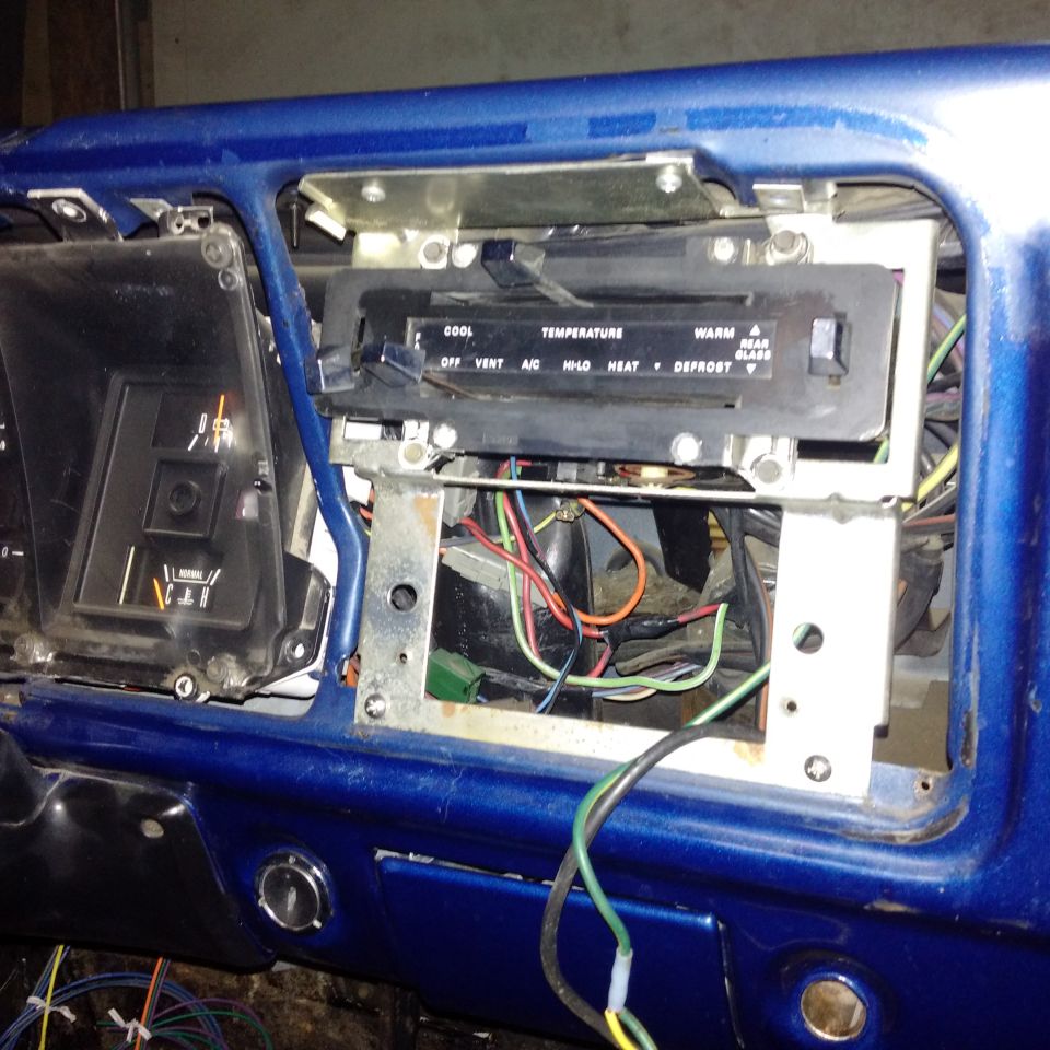 1978 Ford Bronco dashboard interior with exposed wiring and climate controls
