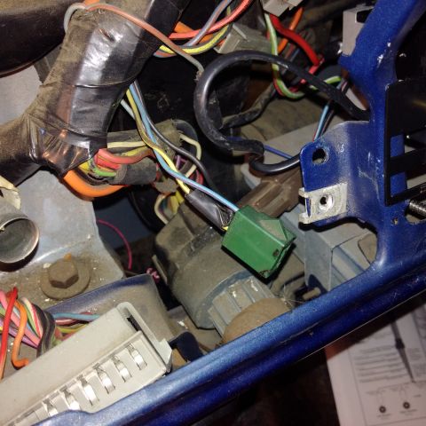1978 Ford Bronco - This image shows a close-up view of a vehicle's ignition switch and a complex wiring harness, indicating an interior electrical system.