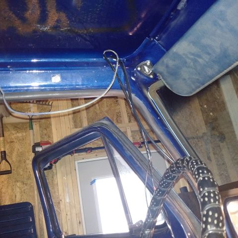1978 Ford Bronco - Interior view of a blue vehicle, showing the steering wheel and door frame.