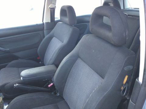 2002 Volkswagen Jetta - Interior view of a 2002 Volkswagen Jetta, showing the front seats and armrest.