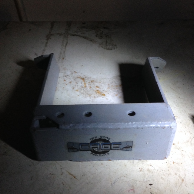 Gray metal bracket with 'OFF-ROAD CAGE PRODUCTS' logo