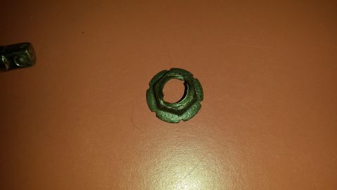 1976 Ford Ranchero - Lug nut and washer shown on a brown surface.