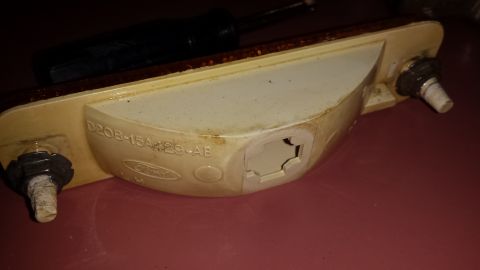1976 Ford Ranchero - This is a close-up of a Ford taillight assembly, showing the part number and a screwdriver resting on top.