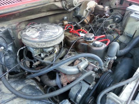 1981 Ford Bronco - The engine bay of a vehicle, showing the carburetor and air filter assembly.