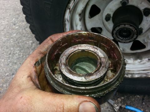 1981 Ford Bronco - A close-up shows a worn wheel bearing assembly, likely needing replacement.