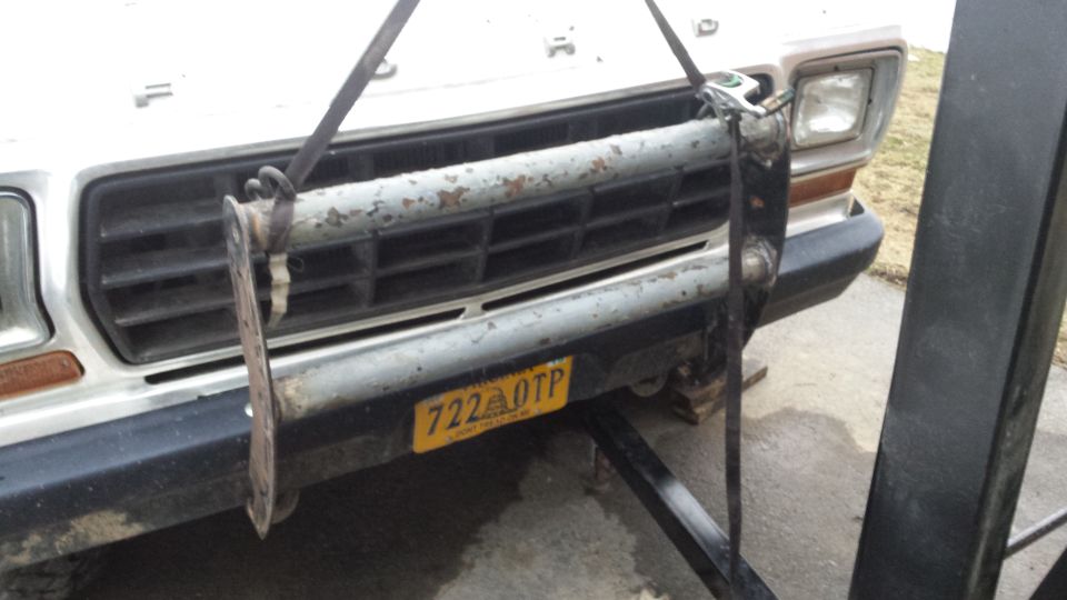 White 1979 Ford Bronco front grille and bumper with a yellow license plate reading 722 OTP