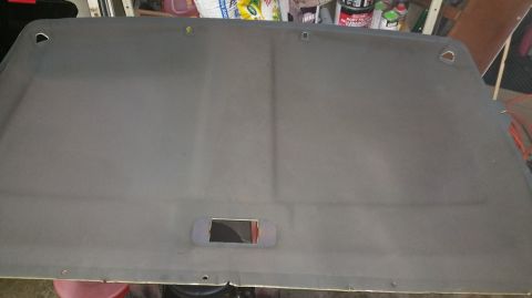 1983 Ford Bronco - Vehicle headliner part shown from below, with a cutout for a light or speaker.