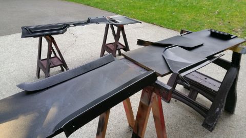 1983 Ford Bronco - Interior trim pieces are laid out on sawhorses, likely for painting or restoration, with a SuperMotors watermark in the corner.