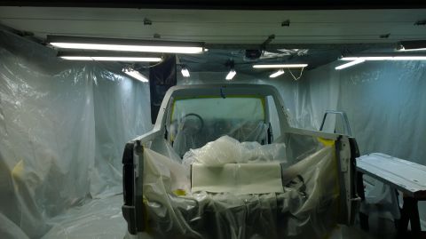 1983 Ford Bronco - A 1983 Ford Bronco is prepped for painting inside a spray booth.