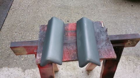 1983 Ford Bronco - Two bumper guards are shown resting on a makeshift stand outdoors.