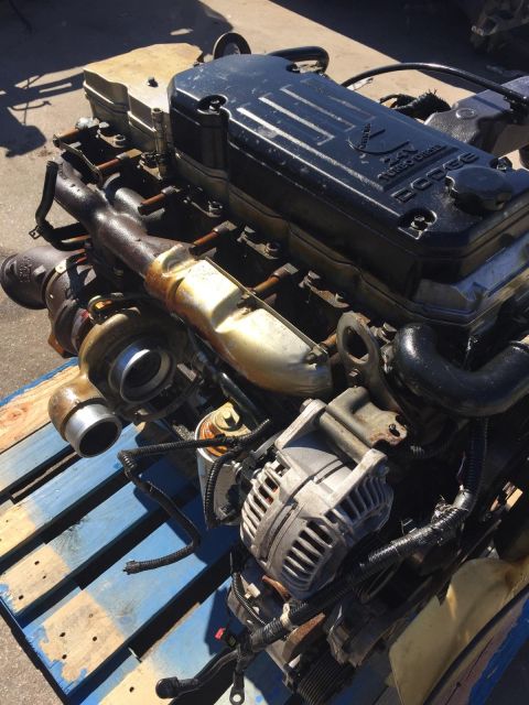 2003 Ford Excursion - Dodge 24V Turbo Diesel engine with turbocharger and alternator visible.