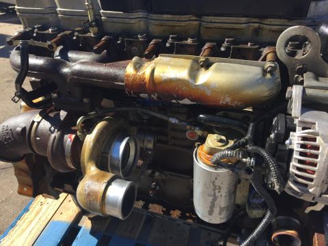 2003 Ford Excursion - Close-up view of a diesel engine's turbocharger and fuel filter assembly.