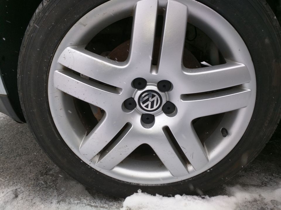 Volkswagen wheel with five spokes and a central logo