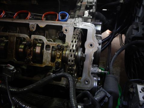2002 Ford Mustang - Close-up view of an engine's timing chain and camshafts, likely during a repair or maintenance procedure.