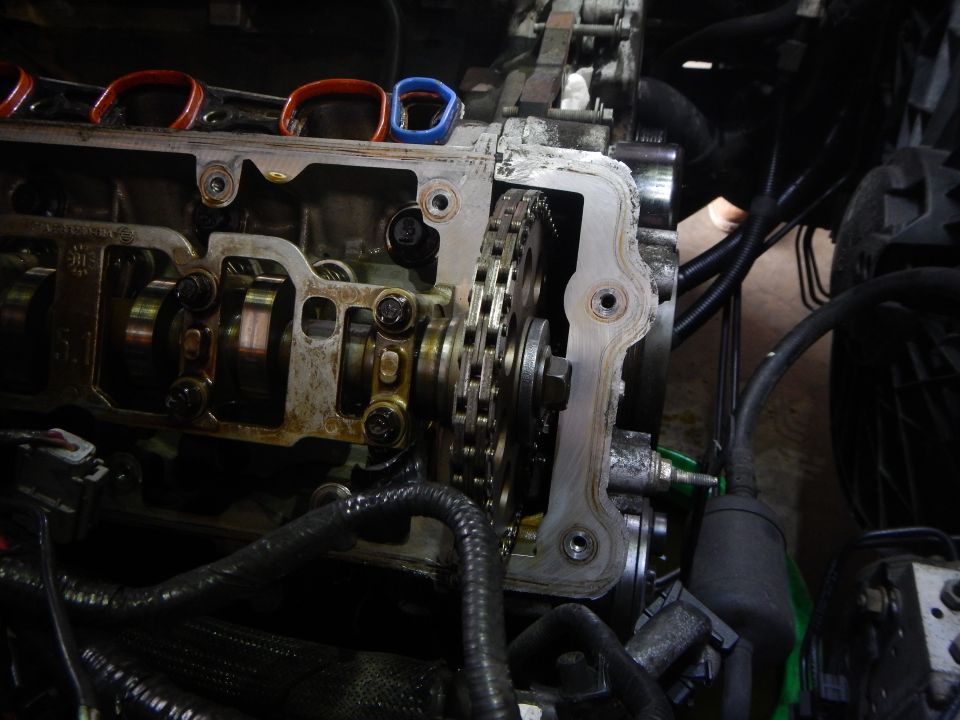Engine timing chain and camshafts exposed during repair