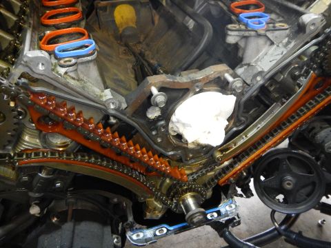 2002 Ford Mustang - Close-up of an engine's timing chain system, showing intricate mechanical components.