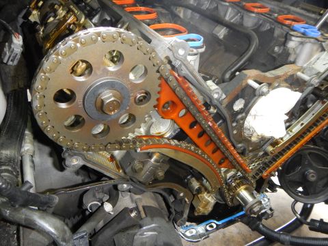 2002 Ford Mustang - Close-up view of engine timing chain and gears during a repair.