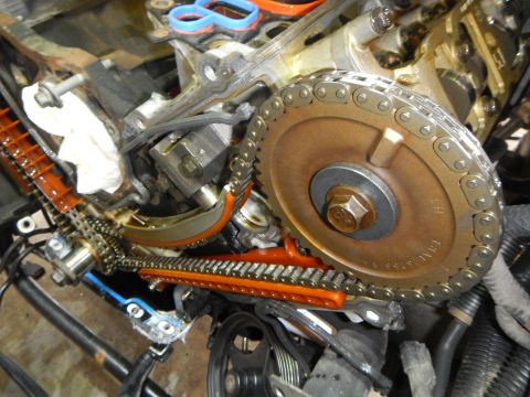 2002 Ford Mustang - Close-up view of engine timing chain and gears during a timing chain replacement.