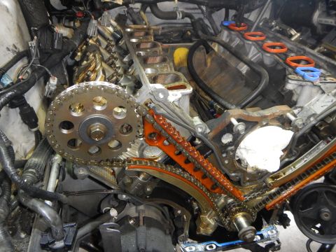 2002 Ford Mustang - Close-up view of an engine's timing chain system, showing gears and tensioners.