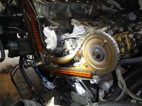 2002 Ford Mustang - Engine timing chain and gears are visible during a timing chain replacement procedure.