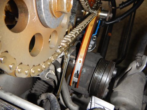 2002 Ford Mustang - Close-up view of an engine's timing chain and tensioner system, likely during maintenance.
