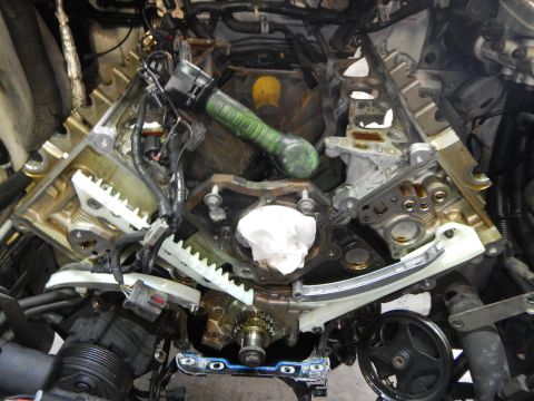 2002 Ford Mustang - Close-up of an engine's timing chain assembly, showing gears and internal components.