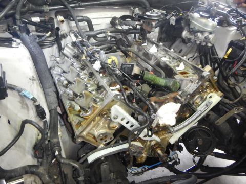 2002 Ford Mustang - The engine bay is shown with internal components exposed, suggesting repair work is in progress.