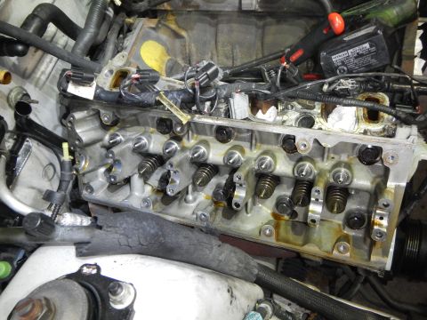 2002 Ford Mustang - Close-up view of an engine's cylinder head, showing internal components and wiring.