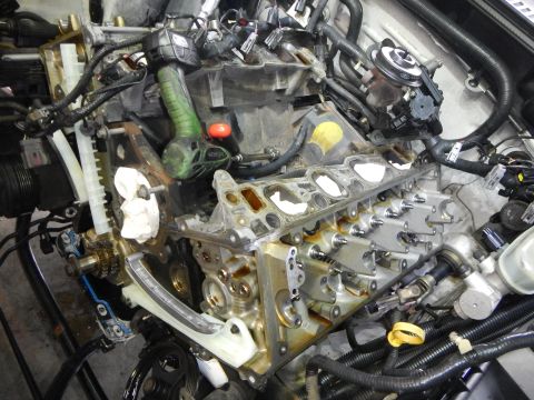 2002 Ford Mustang - Engine components are visible with timing chain guides and gears exposed during a repair.