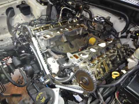 2002 Ford Mustang - Engine components are disassembled, revealing the timing chain and gear mechanisms.