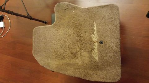 1995 Ford Bronco - Carpet floor mat the Eddie Bauer script logo, likely for an SUV.