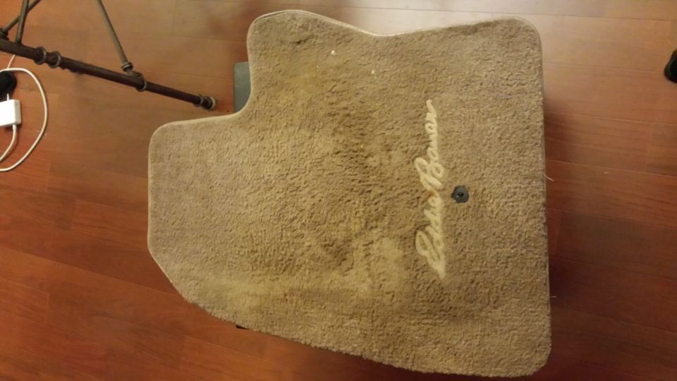 Tan carpet floor mat with embroidered Eddie Bauer script logo