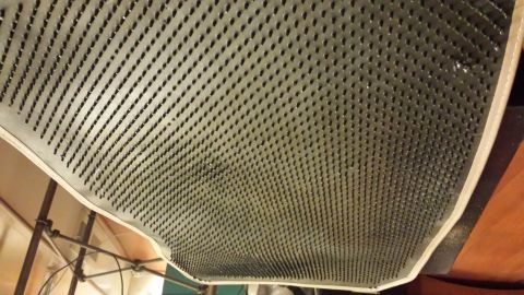 1995 Ford Bronco - A textured gray floor mat with a white edge is shown from an unusual angle.